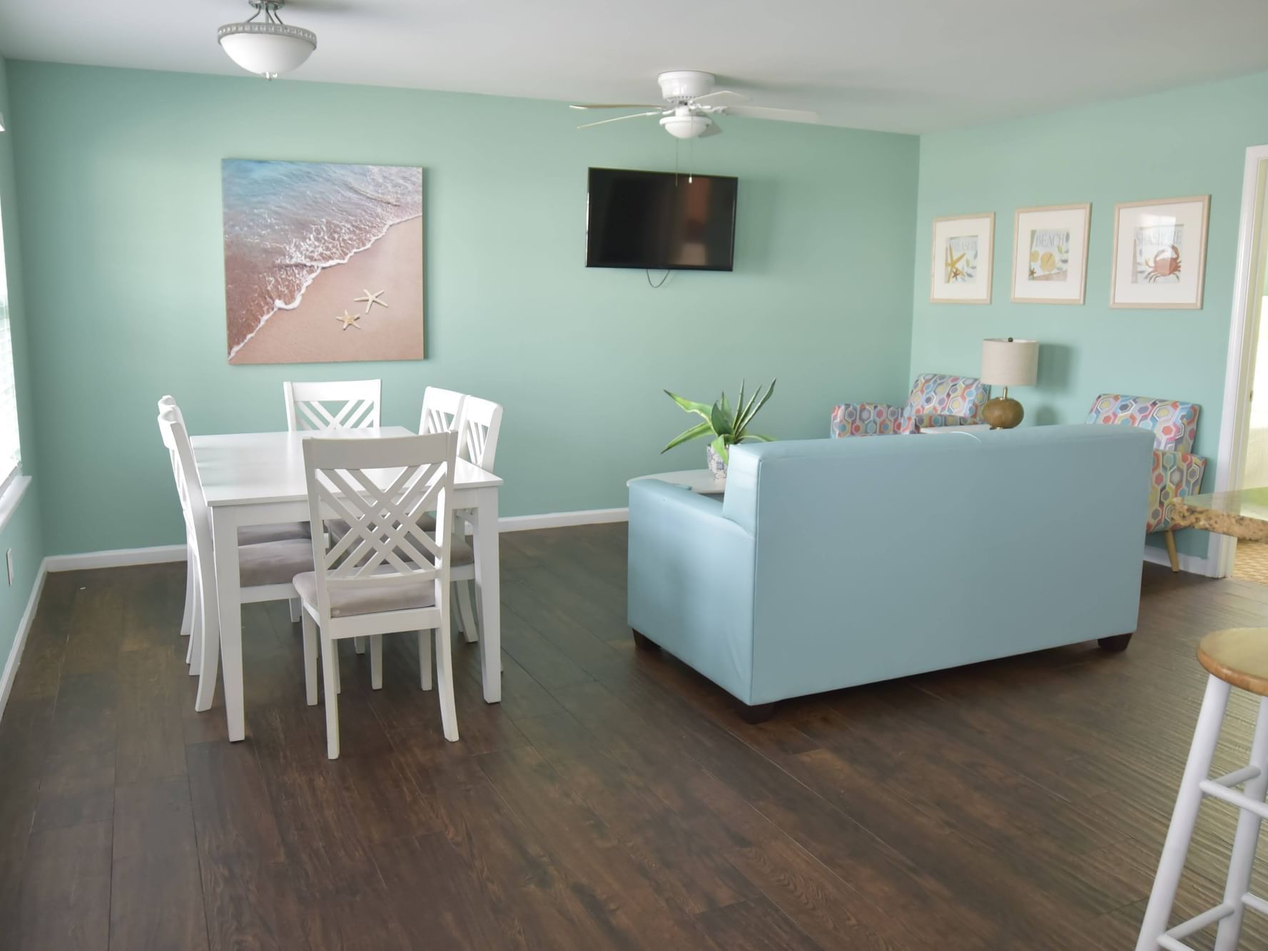 Dining table by TV lounge area in 2 Bedroom Apartment - 4 Queen Beds at South Beach Apartments