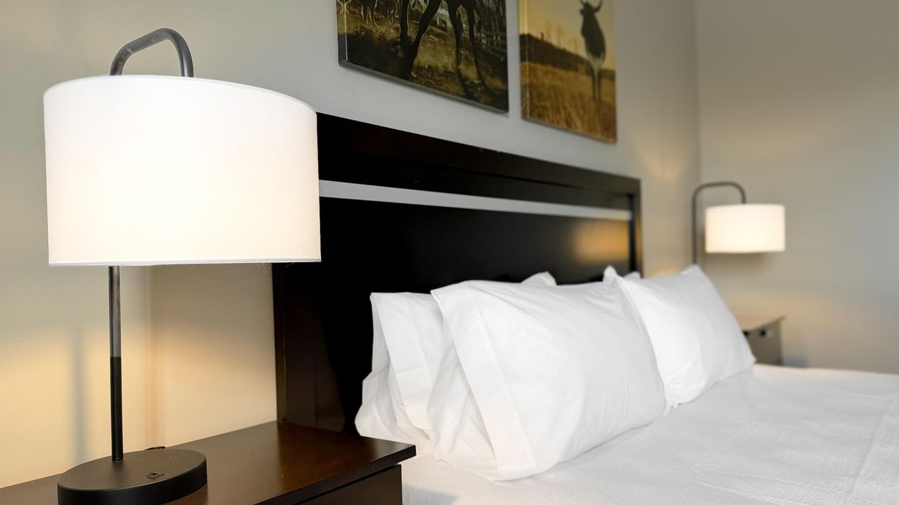 King bed at Coast Innisfail Hotel with bedside lamp
