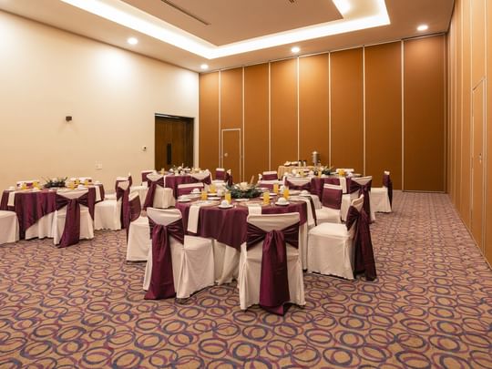 Elegantly decorated event room with round tables at Camino Real Guadalajara in Zapopan