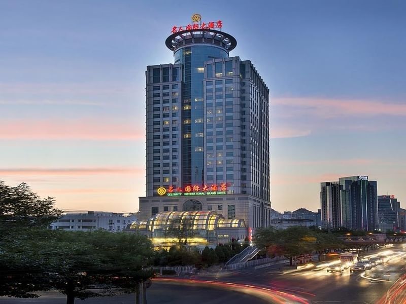 Celebrity International Grand Hotel at sunset with city traffic light trails