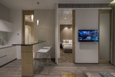 TV, dining space & bedroom area in Suites at Eastin Residences Vadodara