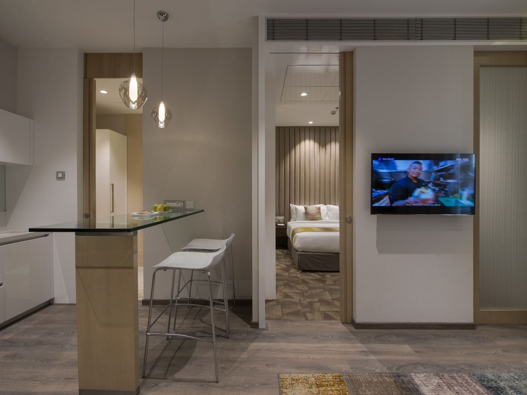 TV, dining space & bedroom area in Suites at Eastin Residences Vadodara