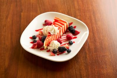 Close-up of a cheesecake & berries at The IowaStater Restaurant