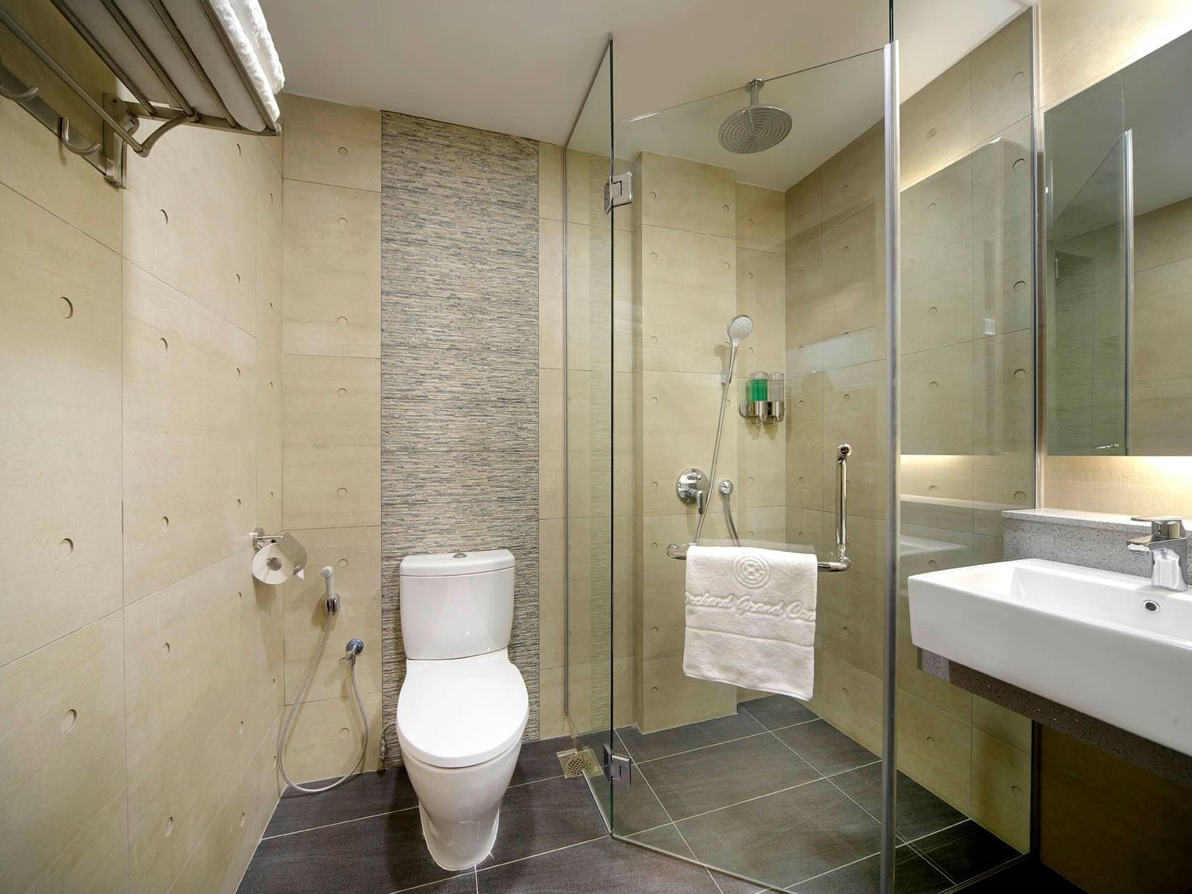 Image 44: Modern One Bedroom bathroom with a glass shower, sleek sink, toilet and neutral-toned tiles at Orchard Grand Court