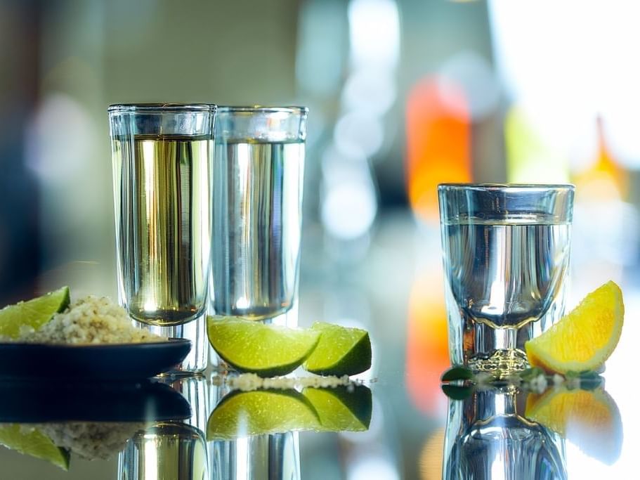 Close-up of Tequila glasses with lime pieces at Gamma Hotels