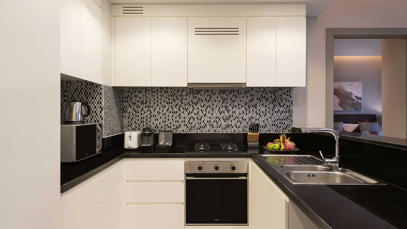 Luxury kitchen area with appliances in Studio Apartments at DAMAC Maison Aykon City