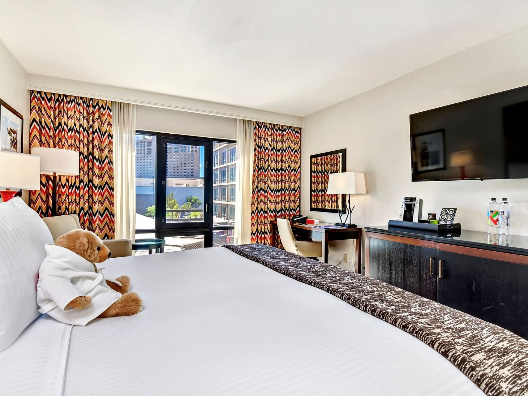 King bed with tv & furniture in a room at Hotel 43