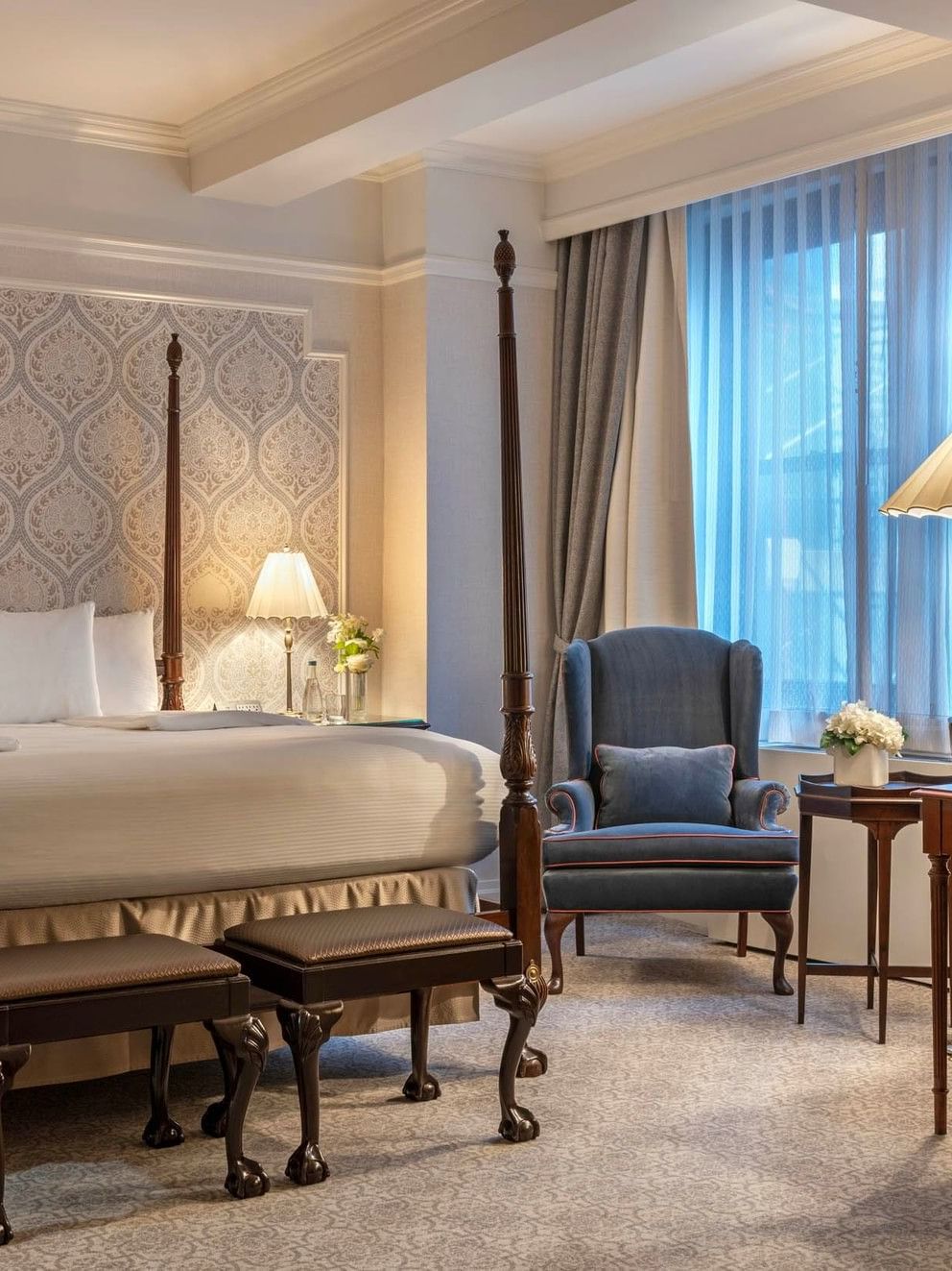 Elegant Suite of the Stars room with four-poster bed and refined decor at Warwick New York