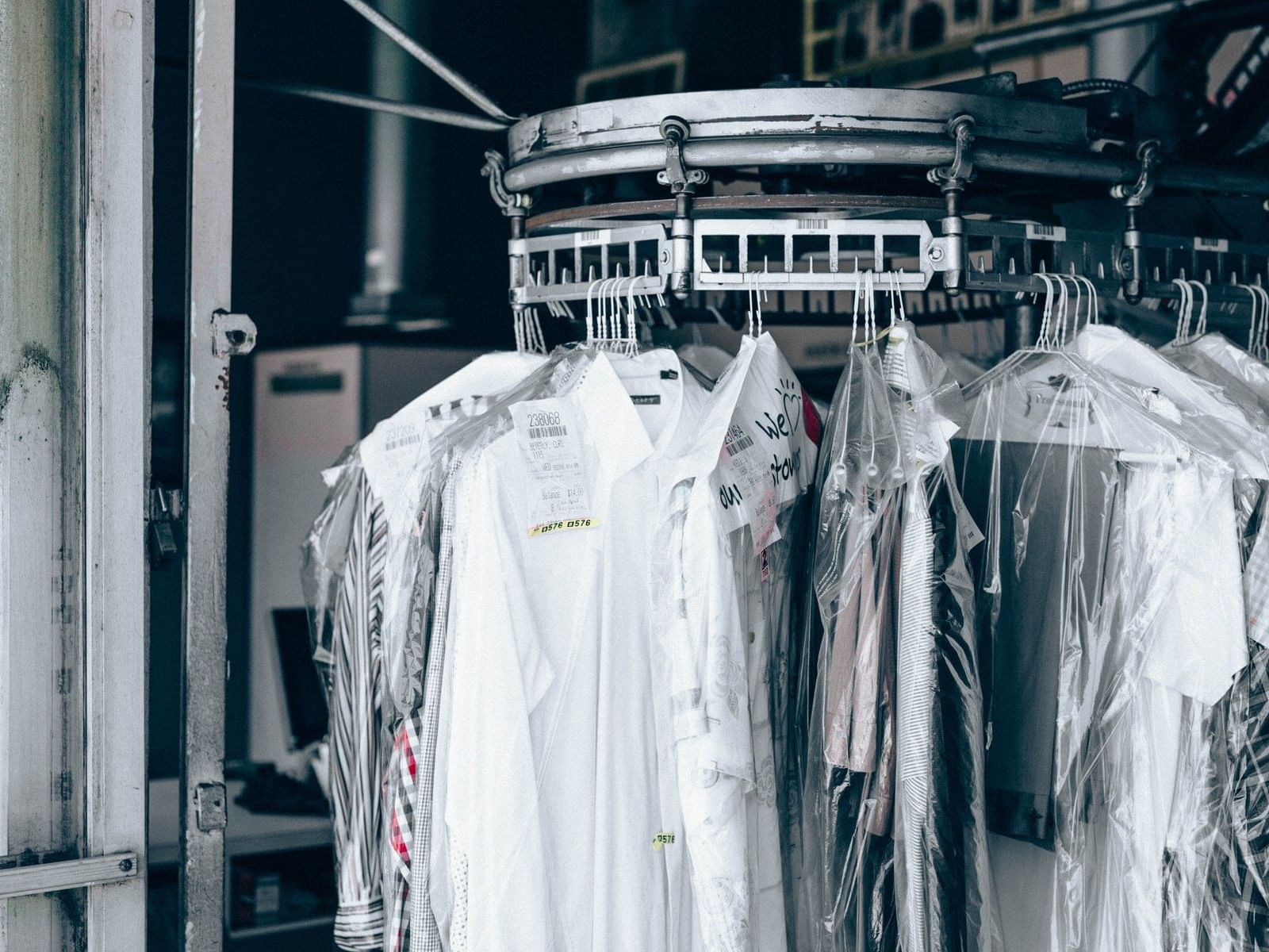 Dry cleaned clothes in a rack at New Haven Hotel