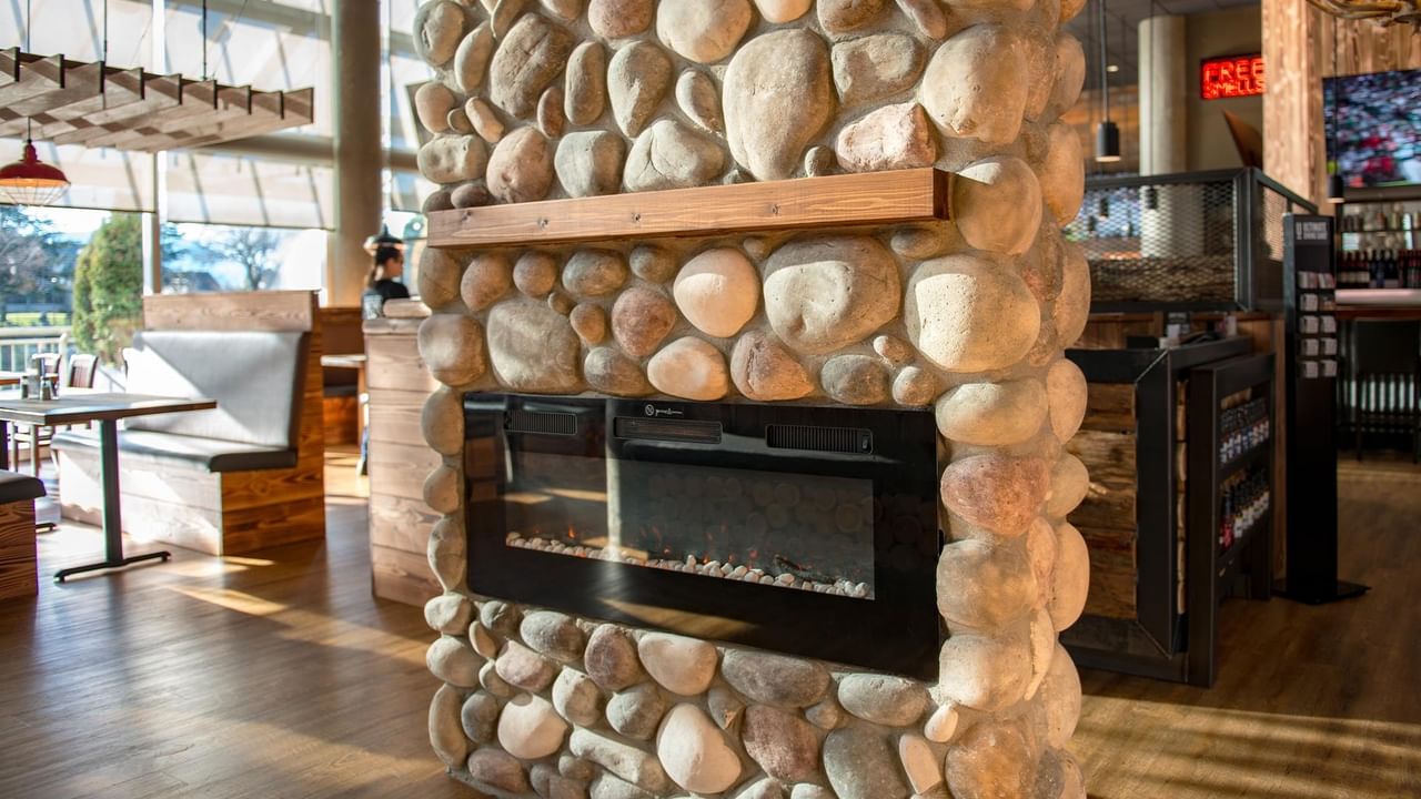 Stone fireplace in a cozy restaurant.