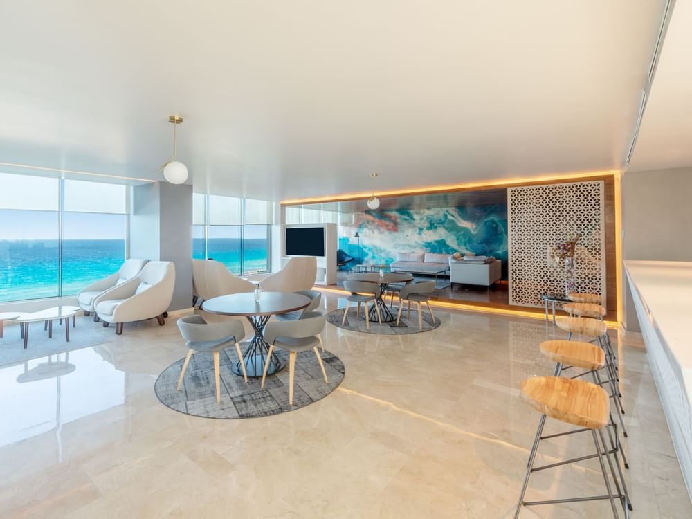 Lounge area on tiled floors overlooking the sea at Live Aqua Cancún