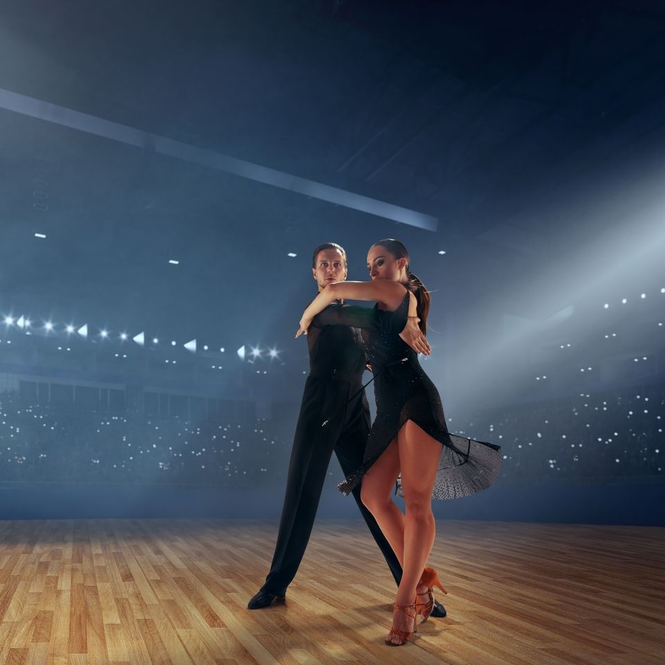 couple salsa dancing on dance floor