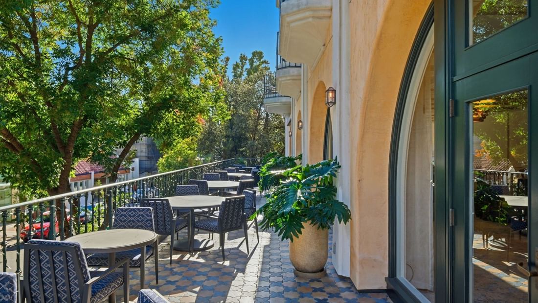 Balcony view outside the La Terazza meeting space, with outdoor seating and greenery at el PRADO Hotel in Palo Alto.