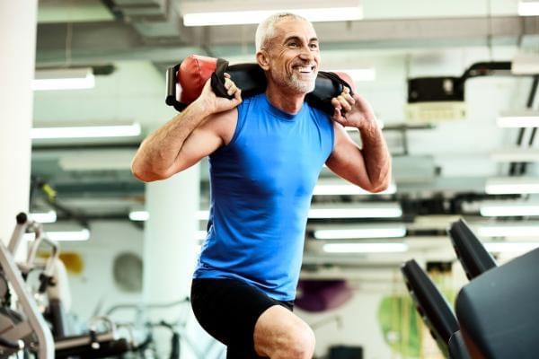 Man practicing sandbag lunges part of Hyrox 