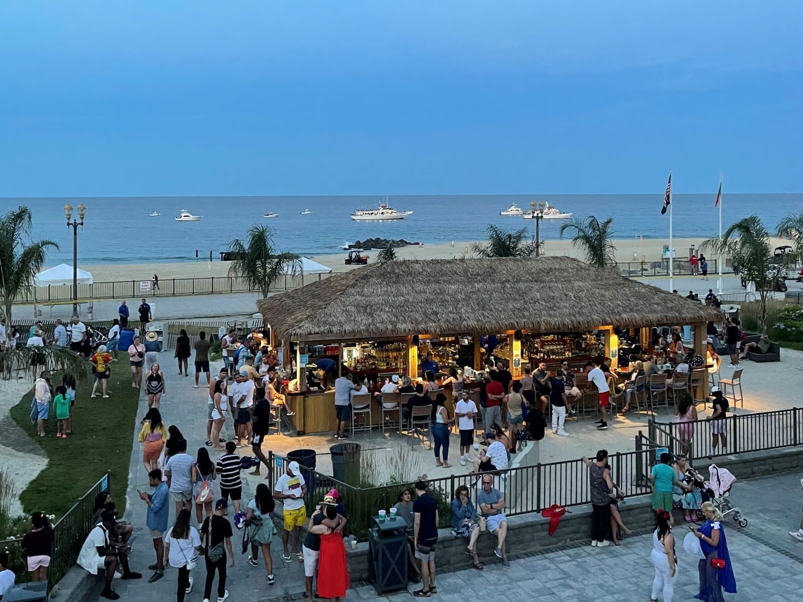 Guests enjoying at Tiki Bar in evening near Ocean Place Resort