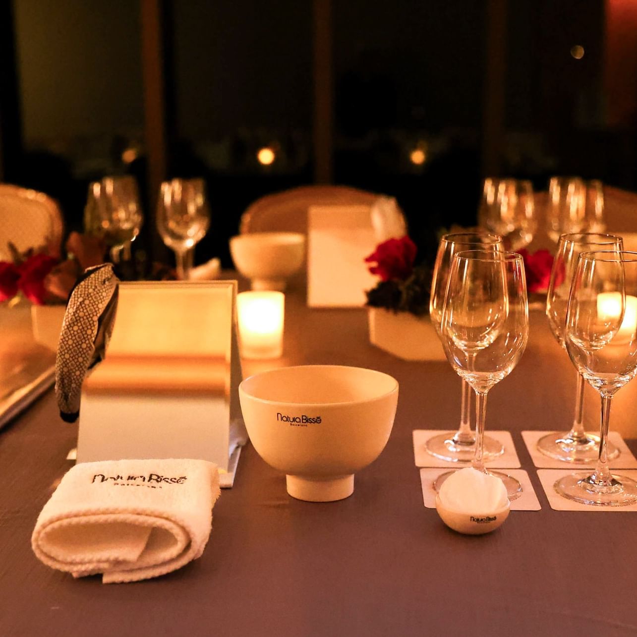 Wine glasses and bowls on a table set for the Beauty Uncorked event.
