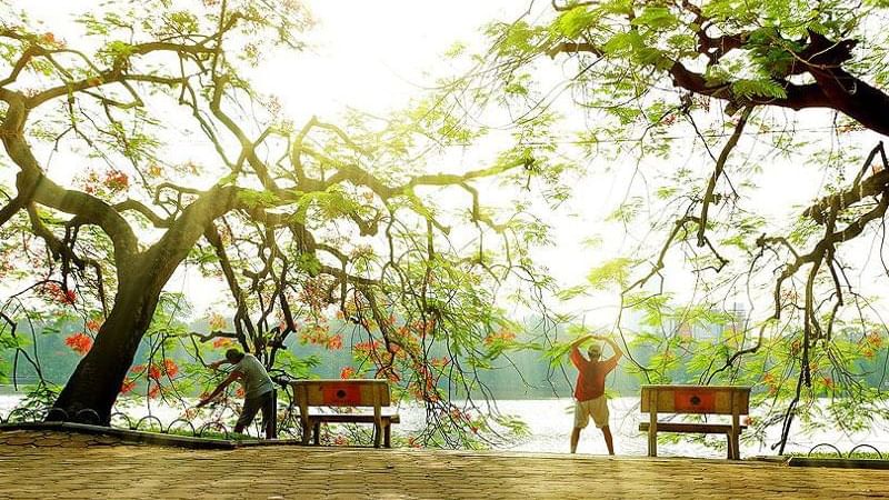 People exercising by the Hoàn Kiếm Lake near Sunway Hotel Hanoi