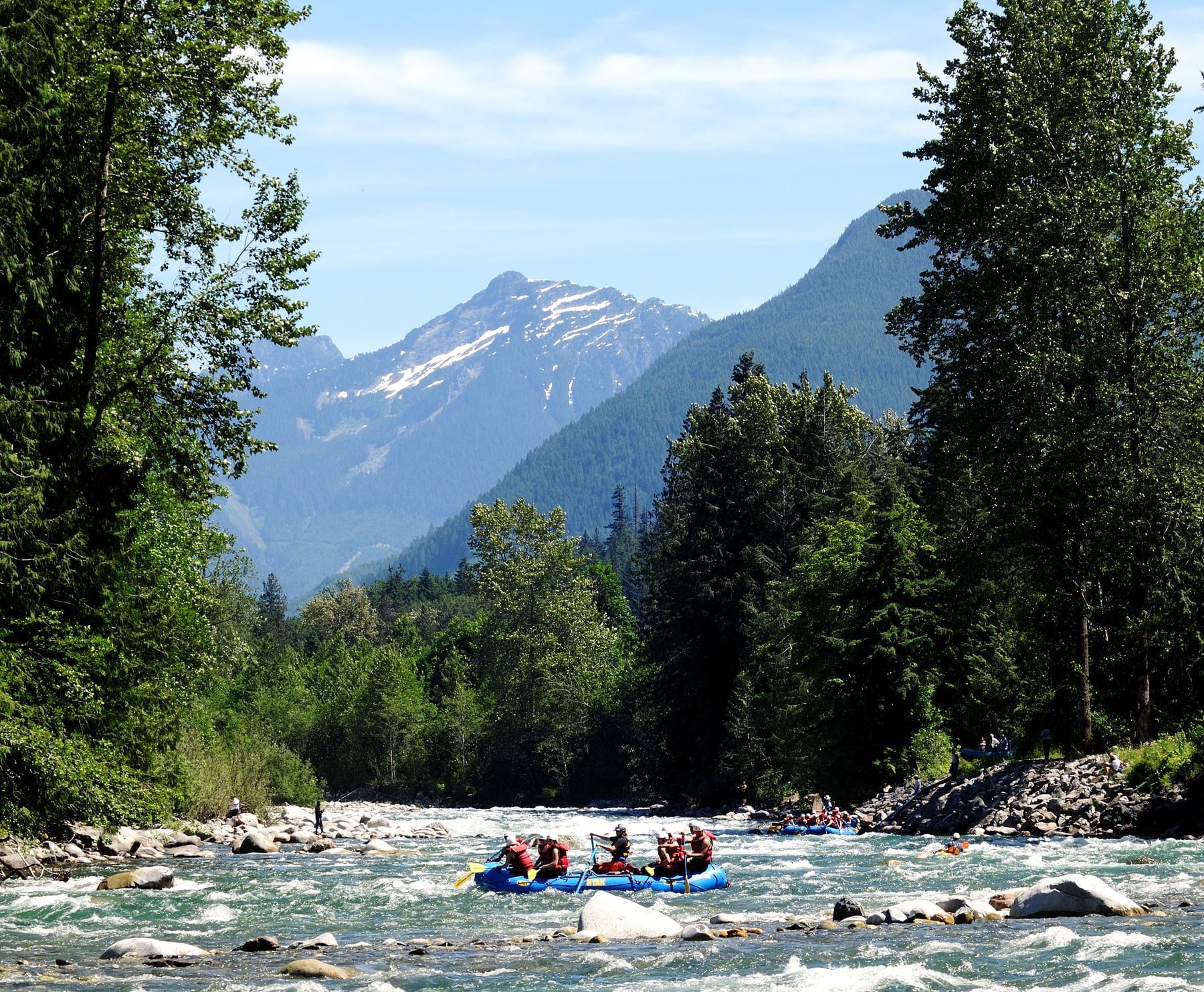 White water rafting with mountains in background