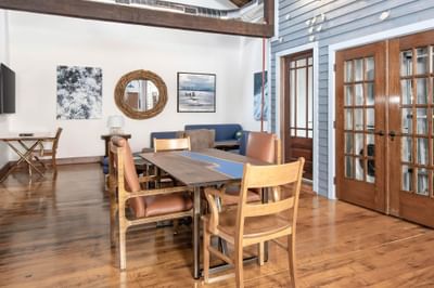 Wooden dining table, TV & sofa in Apartment 403 at Retro Suites Hotel
