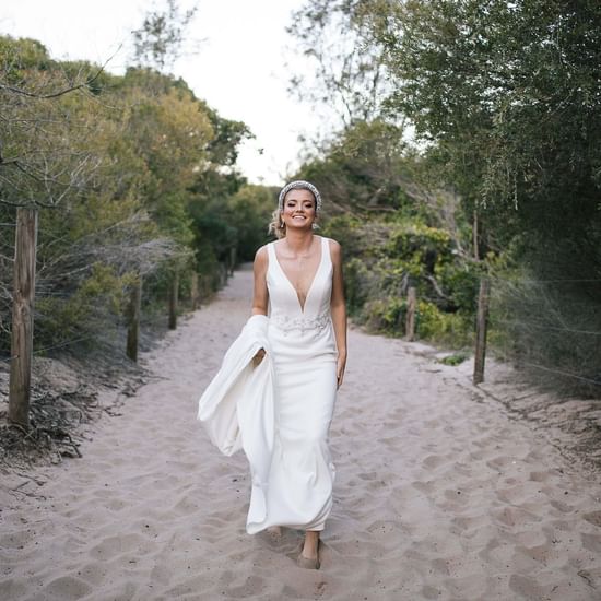 Bride posing on the sandy street near Pullman Magenta Shores