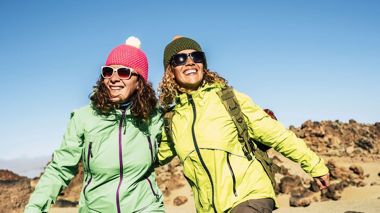 Two Girls wearing sunglasses and smiling 
