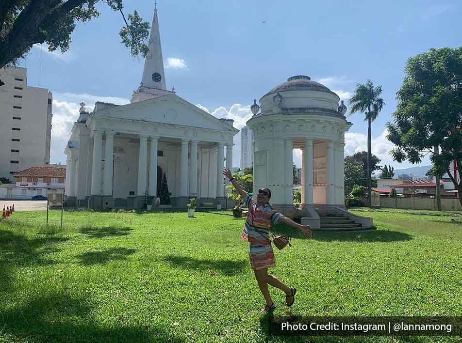 A tourist was taking a picture outside the St. George’s Church - Lexis Suites Penang