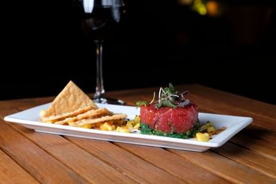 plate of ahi tuna and a glass of wine