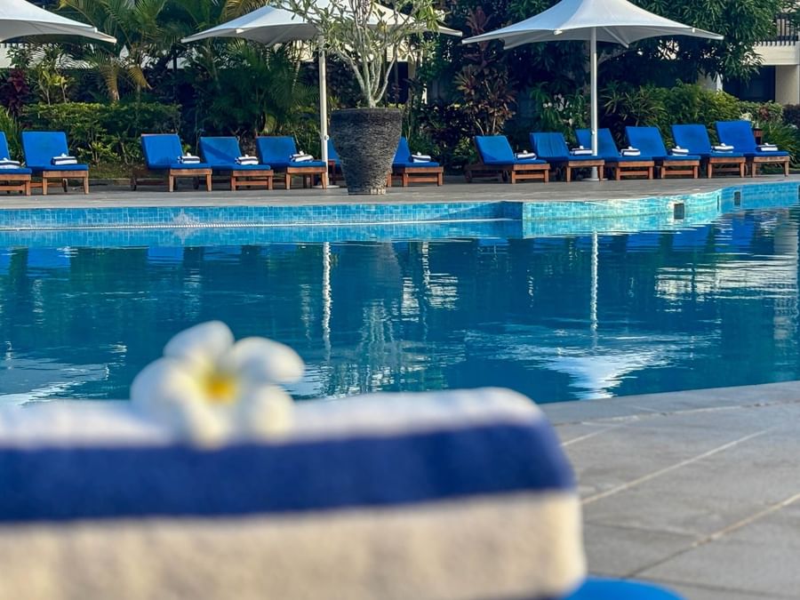 Blue pool loungers and umbrellas at The Naviti Resort Fiji.