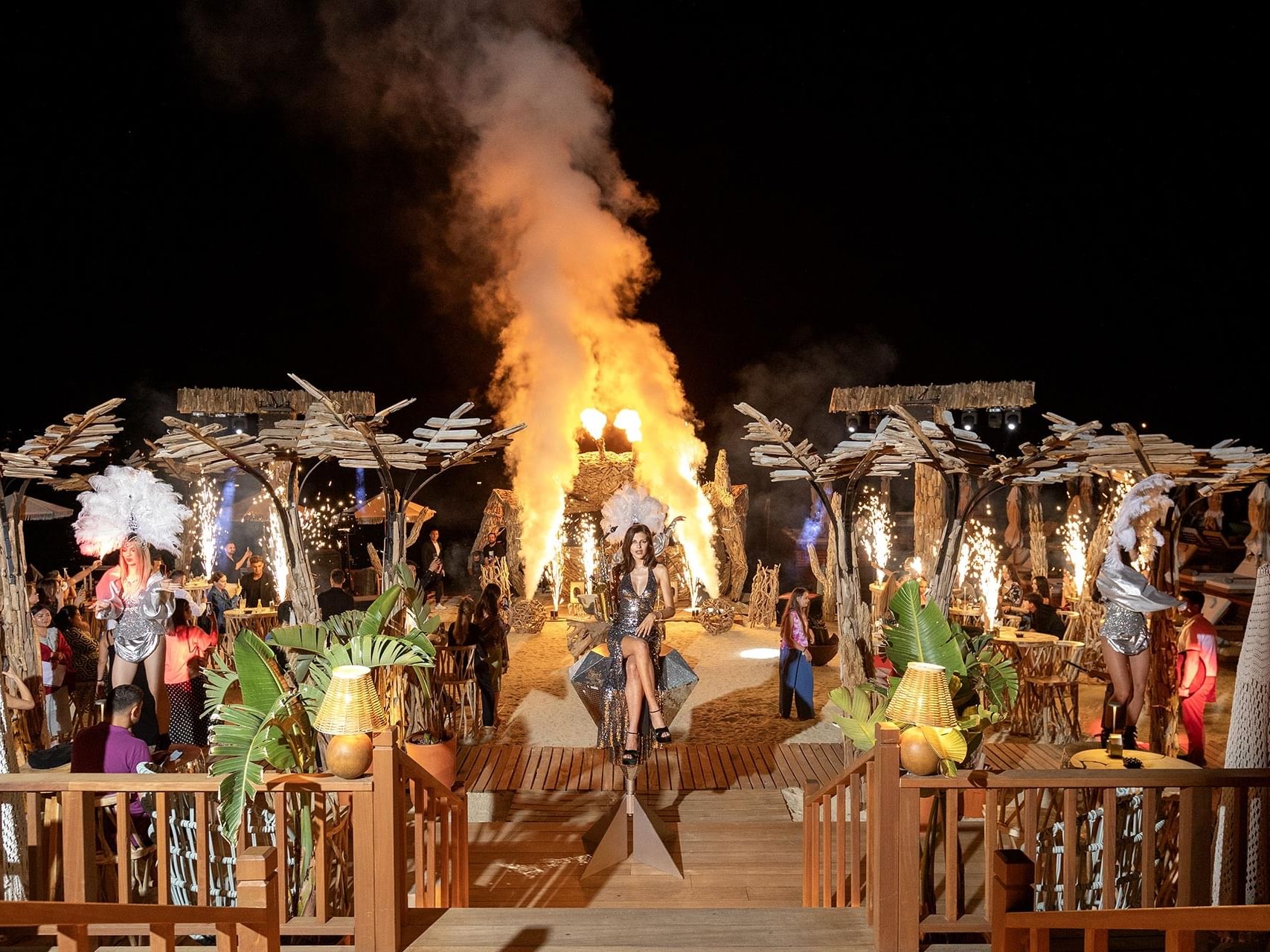 At Titanic Luxury Collection Bodrum, the night event enchants with dancing women and a dramatic fire show in the background.