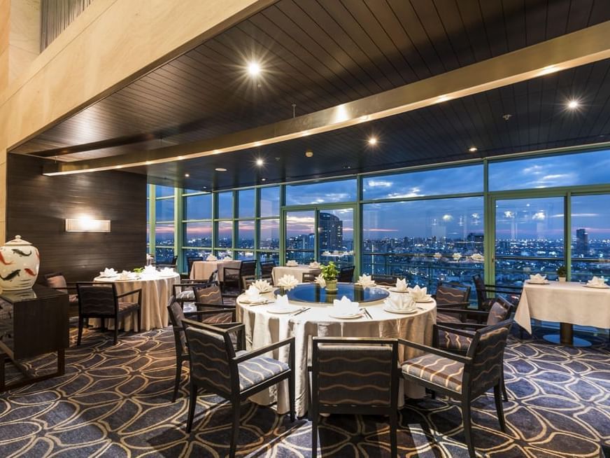The evening city view of River Barge Restaurant at Chatrium Hotel Riverside Bangkok 