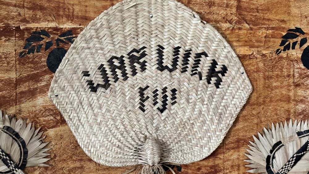 Woven fan with WARWICK printed in black at Warwick Fiji Resort and Spa Korolevu.