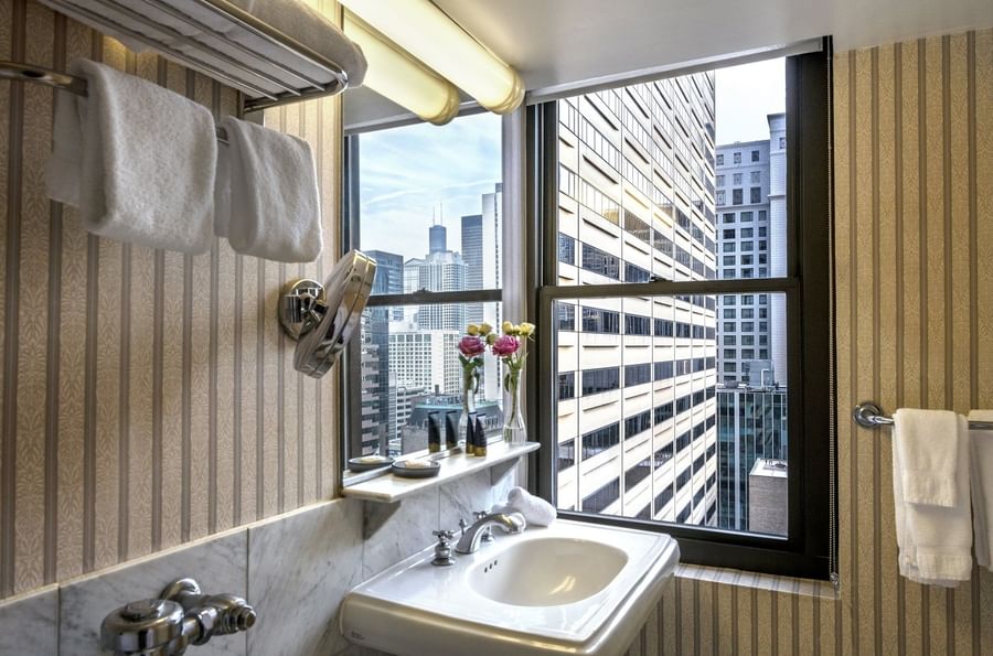 Bathroom 3Elegant bathroom with city skyline view from the window in Superior Suite at Warwick Allerton Chicago