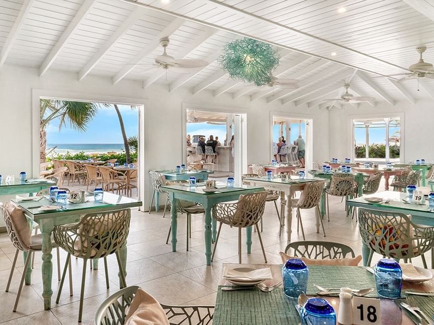 Dining tables arranged in the Reef Restaurant at Sugar Bay Barbados