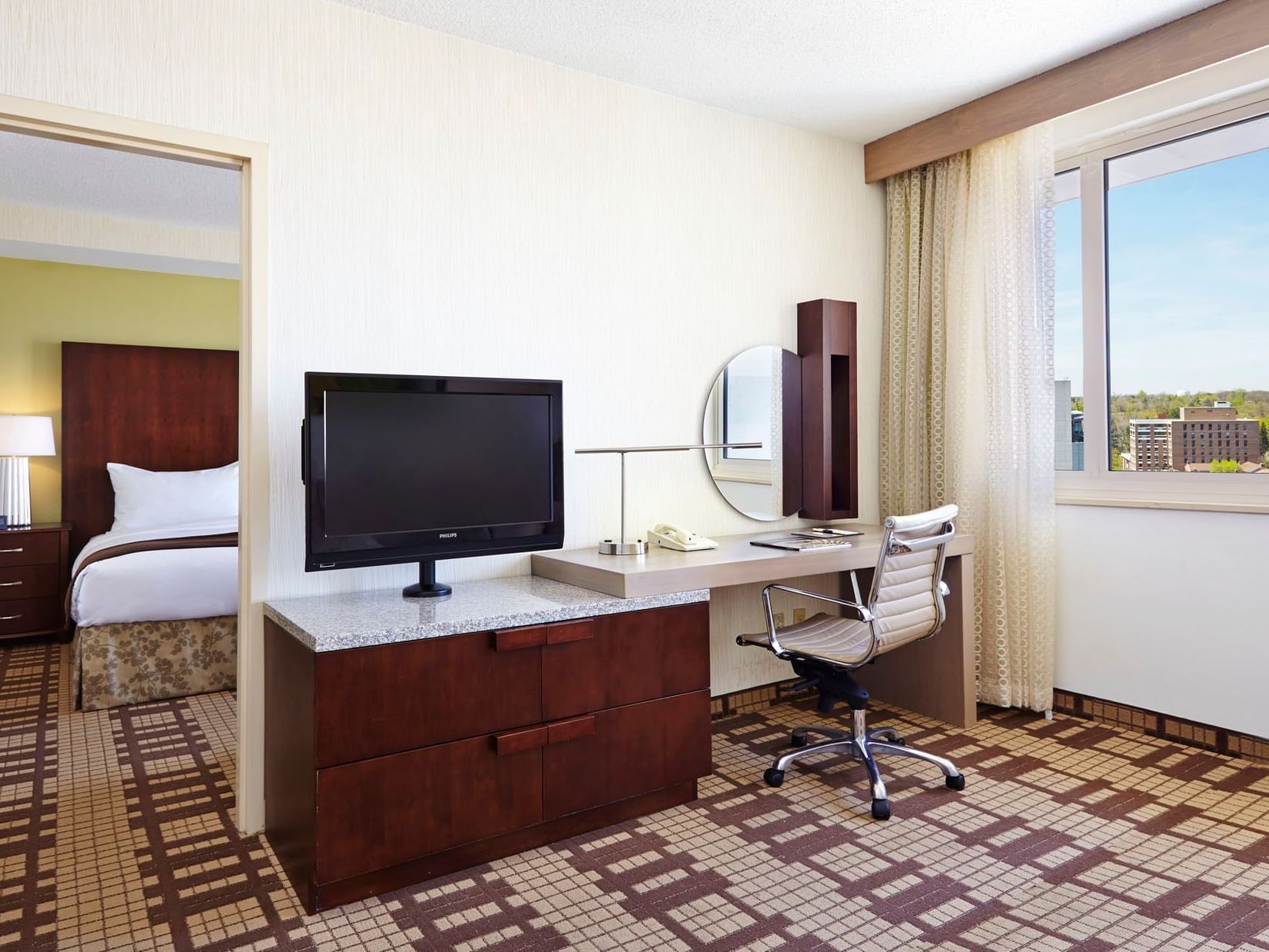 TV stand & desk in 1 King Bedroom Suite at Hotel Silver Spring