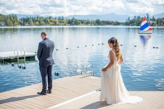 First Look moment of a couple by the lake at High Peaks Resort