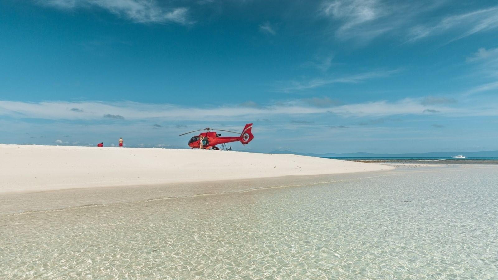 Distant view of helicopter on Vlas off cay at Pullman Port Douglas Sea Temple Resort & Spa