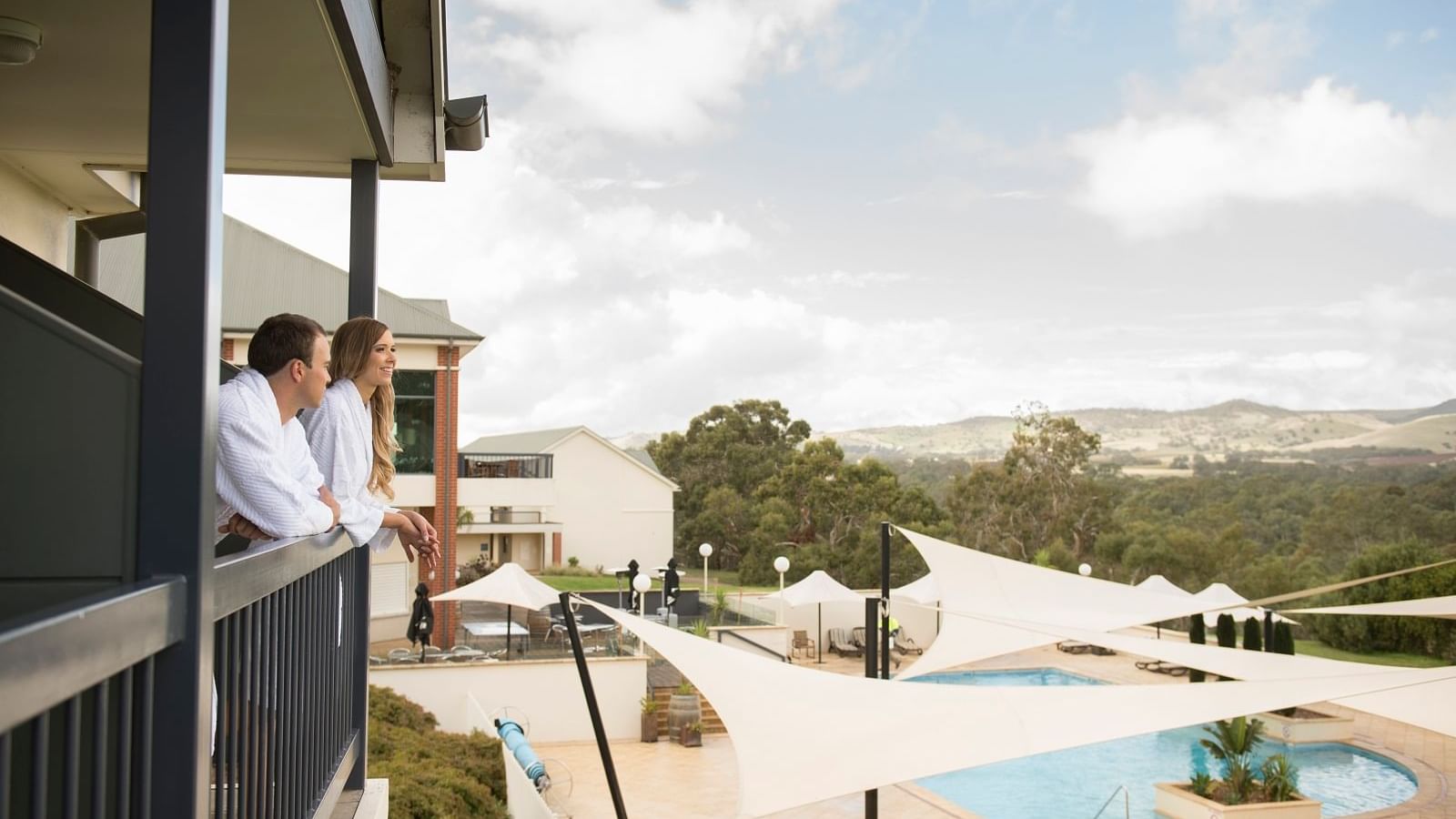 A couple relaxing at the balcony of Novotel Barossa Valley