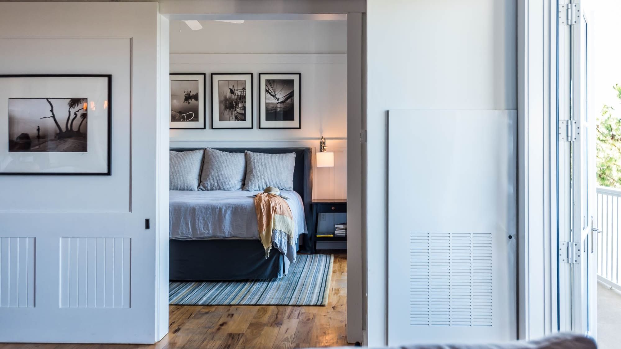 Comfy bed with living area in Premium Resort Suite at Watersound Inn