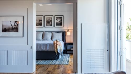 Comfy bed with living area in Premium Resort Suite at Watersound Inn