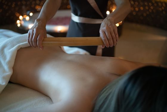 Lady getting a body massage in spa at Okura Prestige Bangkok