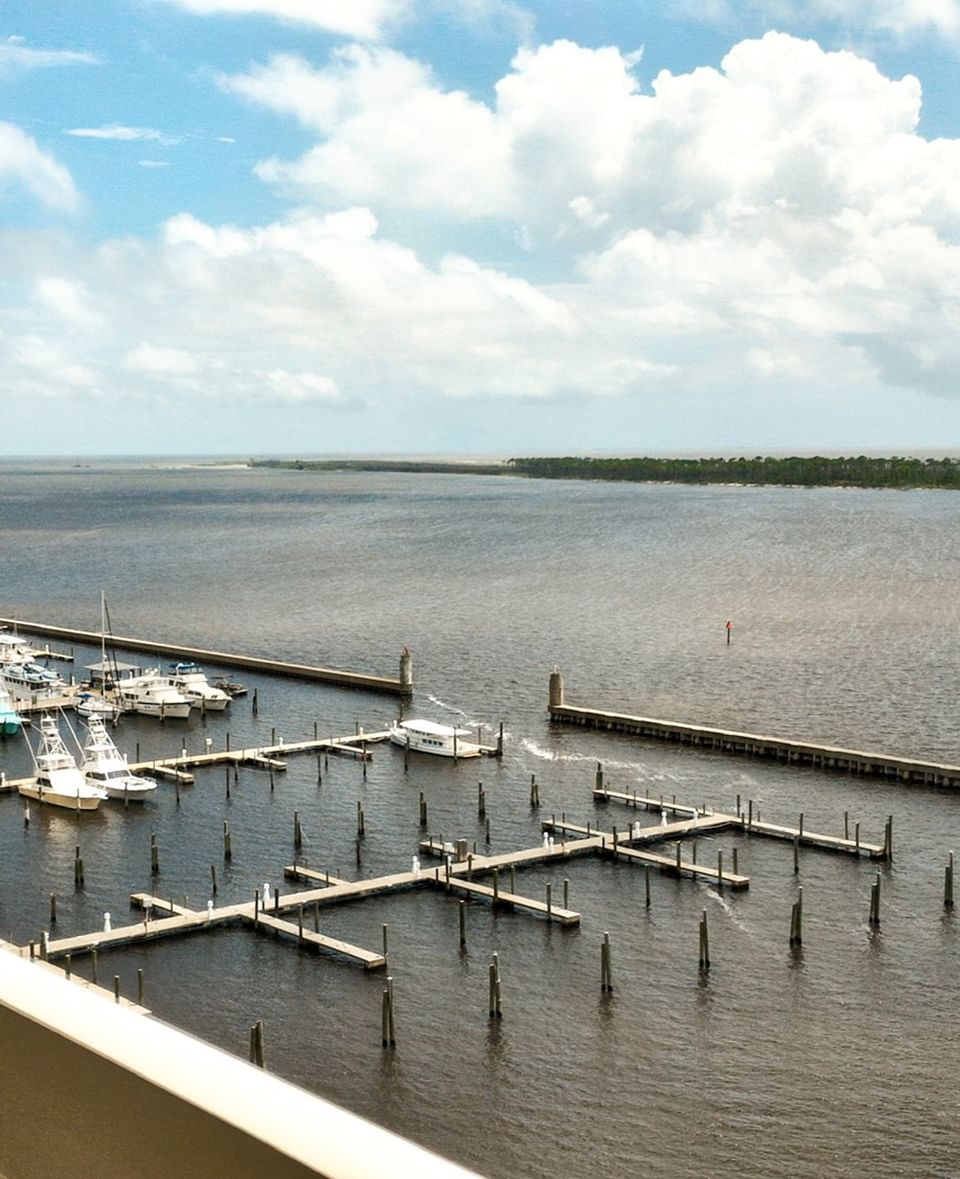 Scenic view of the boat docks and calm coastal waters near Margaritaville Resort Biloxi on a bright day