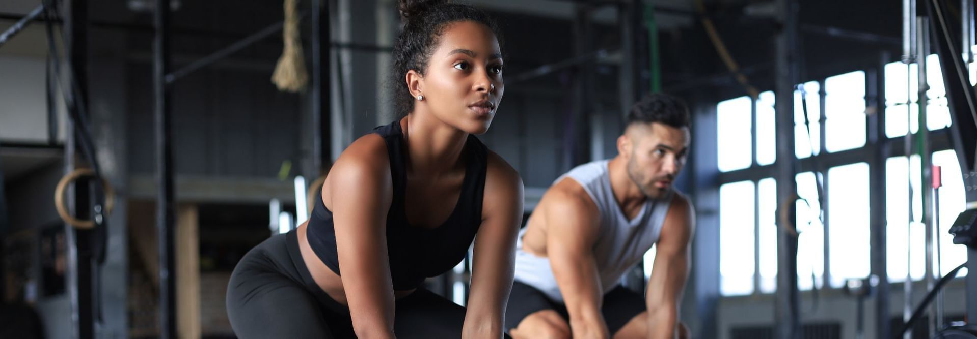 Woman and man working out with kettle balls