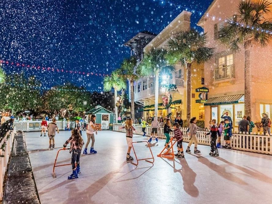 People ice skating outdoors at night near Lake Buena Vista Resort Village & Spa