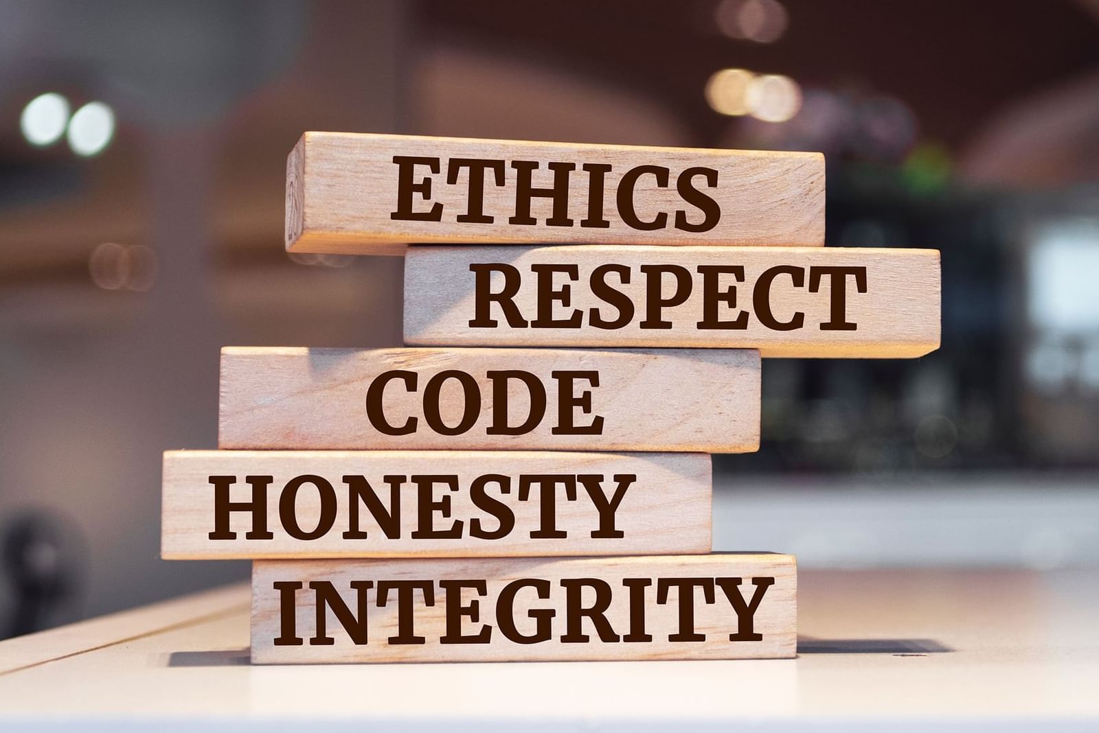 Wooden blocks stacked with words Ethics, Respect, Code, Honesty, and Integrity at Warwick Hotels and Resorts