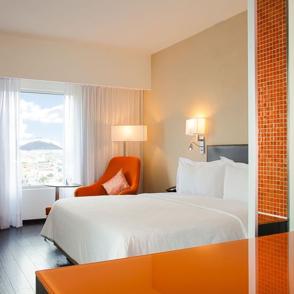 The king bed & lounge in Superior Room at Fiesta Inn