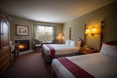 Two Queen bedroom with fireplace and window view