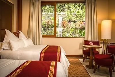 Interior of a room with two king beds at Hotel Sumaq