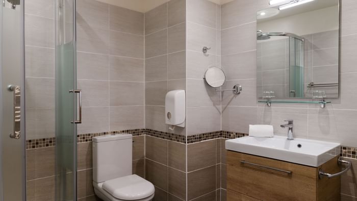 Bathroom shower & vanity area in a room at Hotel du Parc