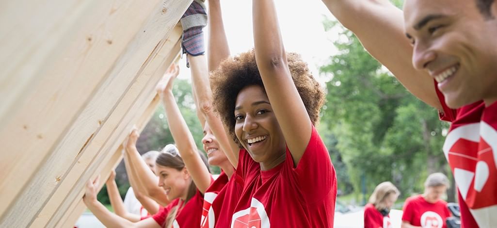Volunteers working lifting construction materials