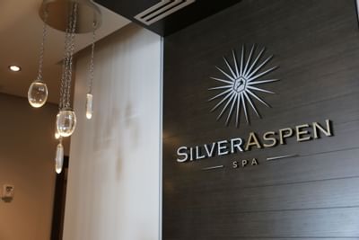 Silver Aspen Spa entrance with logo displayed on the wall at Stein Eriksen Residences